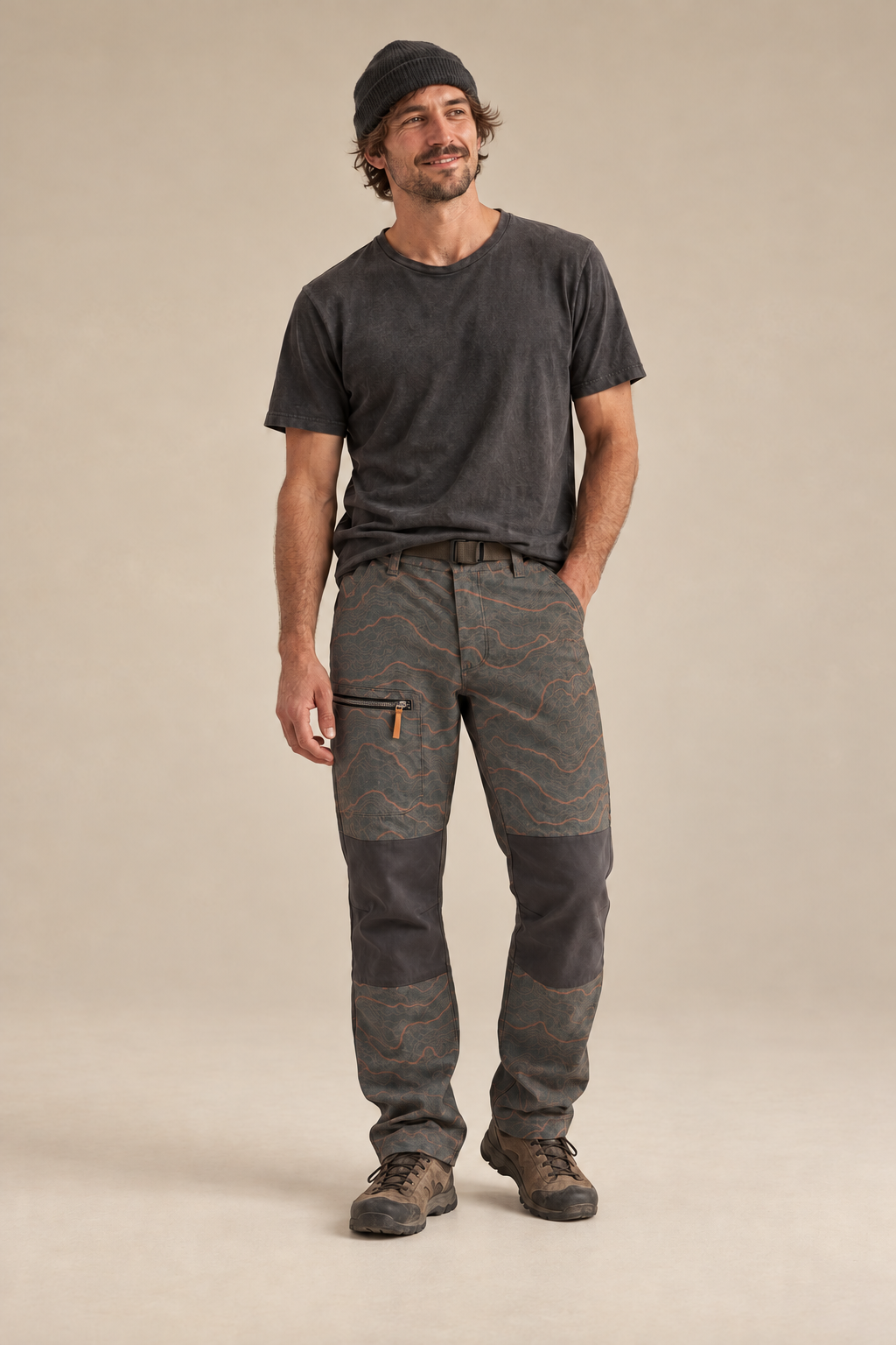 Relaxed model wearing Backcountry topographic pants with continuous charcoal knee panels.