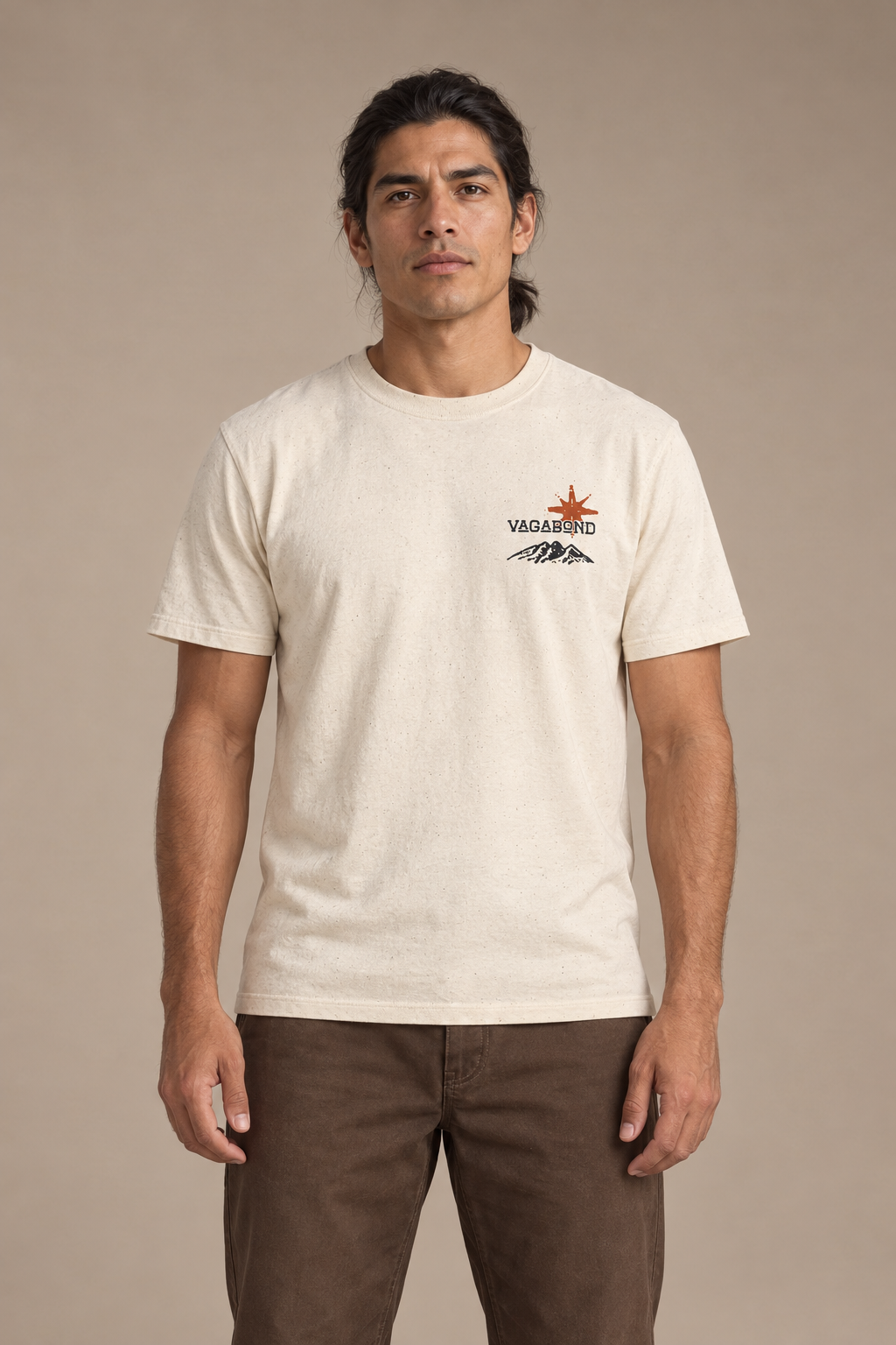 Vagabond tee front — model photograph against warm beige studio background